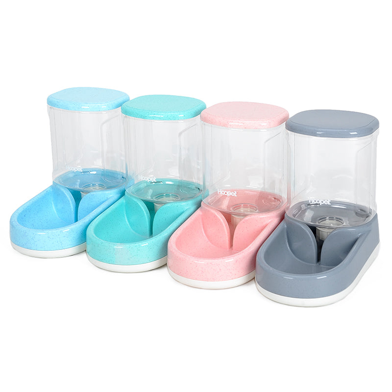 Set of pet feeding and water bowls in pastel colors on a white background