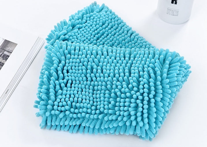 Blue Chenille Cloth on a White Surface with a Magazine