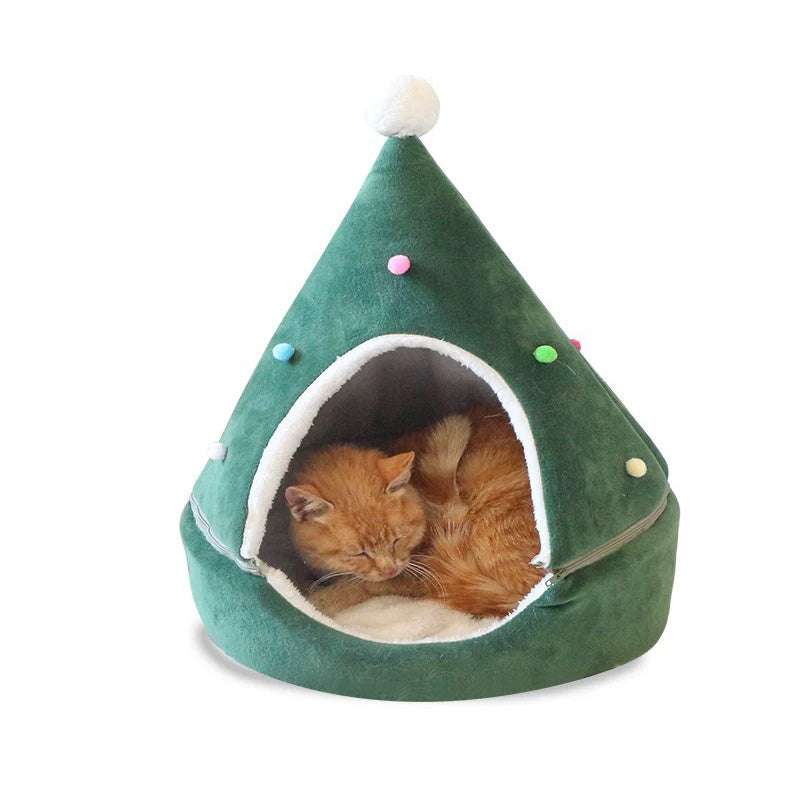 Green pet bed shaped like a Christmas tree with a cat inside on a white background