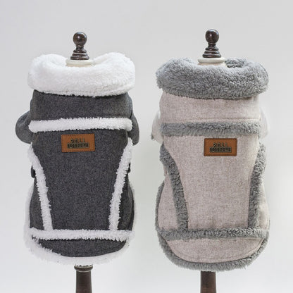 Two dog coats on mannequins with a visible brand label against a white background