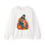 White crewneck sweatshirt featuring a little girl cuddling an orange tabby kitten among autumn leaves