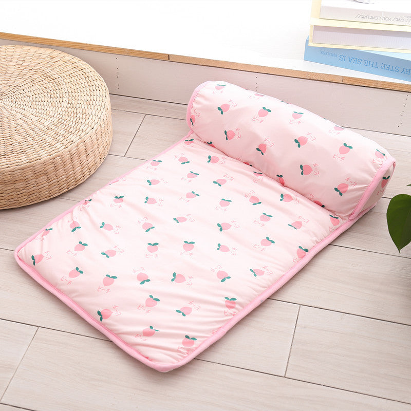 Pink mattress with cherry pattern on a wooden floor