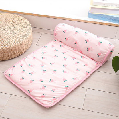 Pink mattress with cherry pattern on a wooden floor