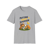 A heather gray short-sleeve crewneck t-shirt featuring a graphic of an orange tabby cat sleeping on a golf green with a golf ball and a yellow flag, with the text 'PUTTING GREEN SUPERVISOR' printed above.