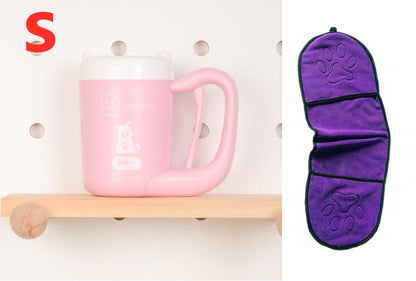 Pink mug on a wooden shelf with a purple paw-patterned item next to it.