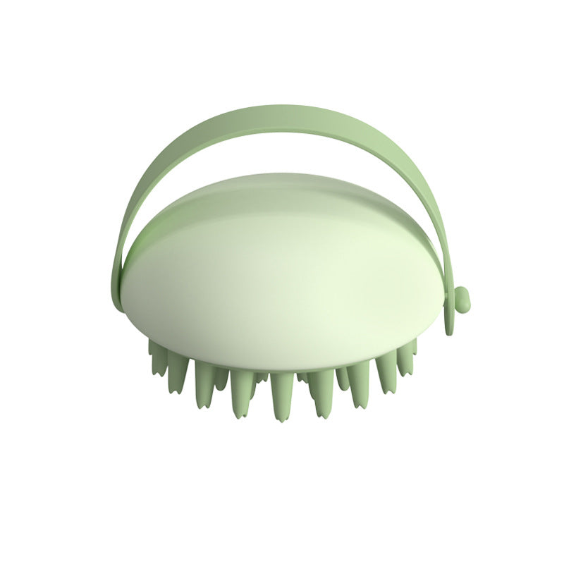 Green scalp massager on a white background