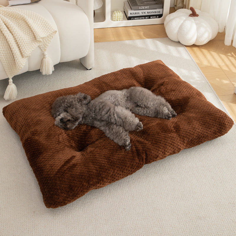 Two dogs sleeping on a brown dog bed in a cozy living room.