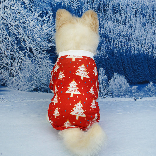 Dog wearing a red Christmas-themed outfit in a snowy landscape