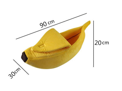 Yellow plush banana-shaped pet bed with measurements on a white background