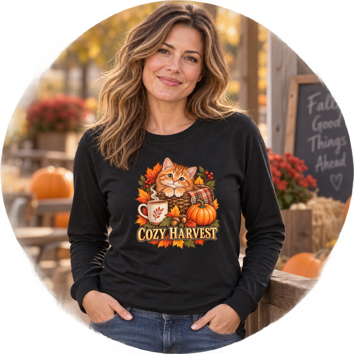 Person wearing a Cozy Harvest kitten long-sleeve shirt with an orange tabby, pumpkin and autumn foliage design
