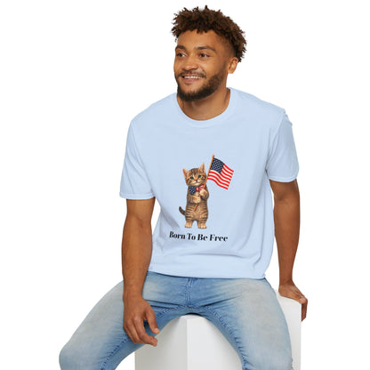 Man wearing a light blue t-shirt with a cat graphic and text, sitting on a white stool.