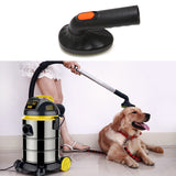 Vacuum cleaner with a brush attachment and a dog sitting on the floor.