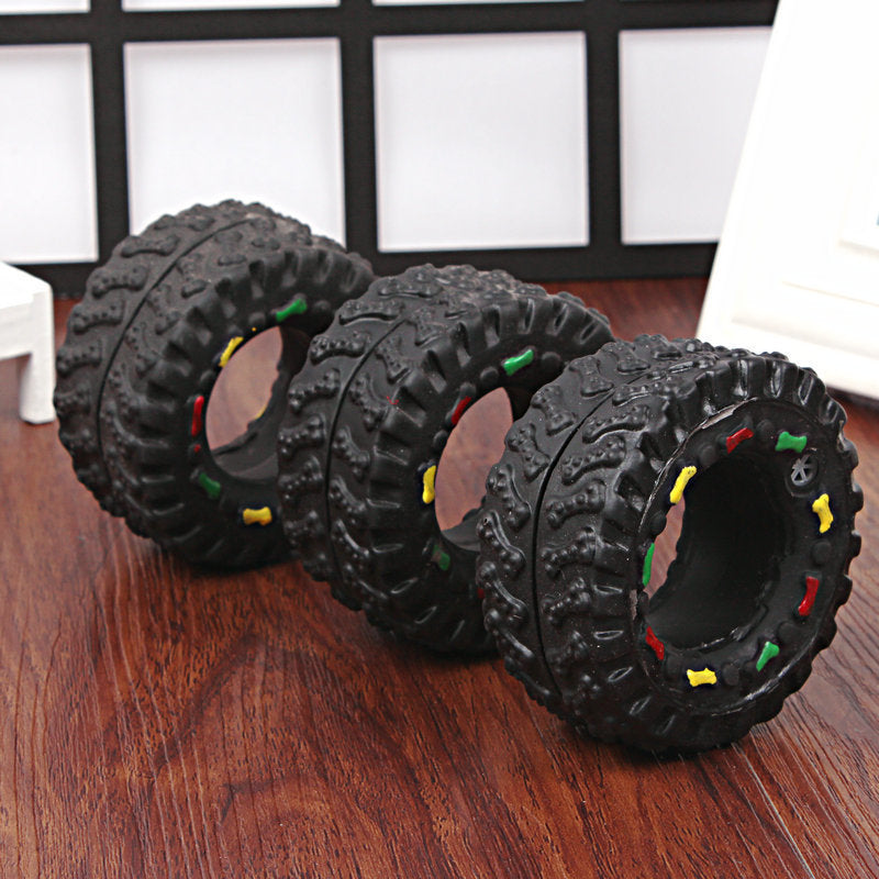 Three black textured balls with colorful accents on a wooden surface.