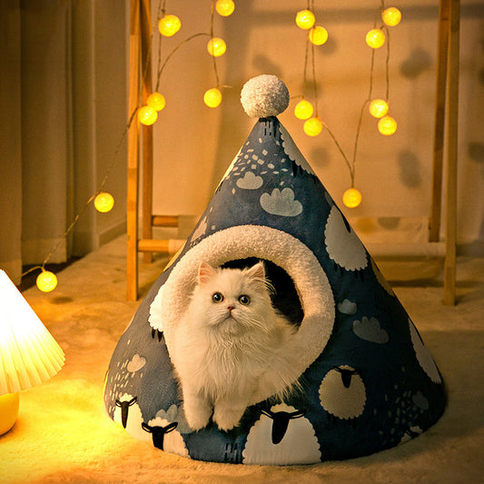 White cat inside a blue pet tent with cloud patterns, surrounded by string lights.