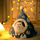 White cat inside a blue pet tent with cloud patterns, surrounded by string lights.