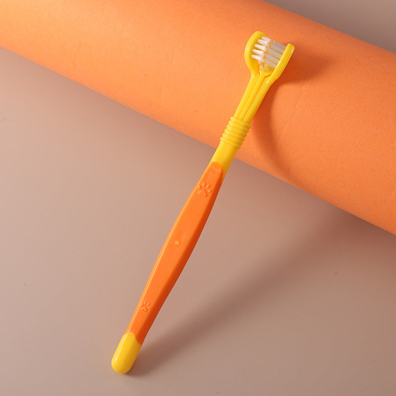 Yellow and orange toothbrush on a brown background