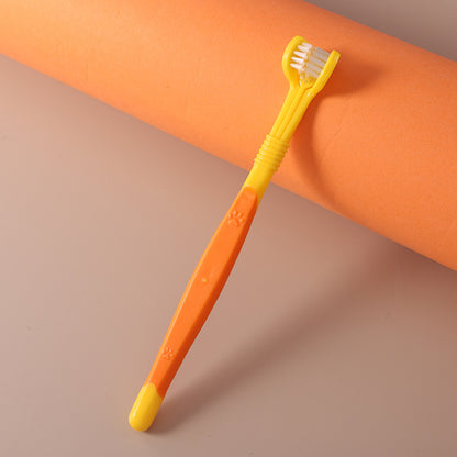 Yellow and orange toothbrush on a brown background