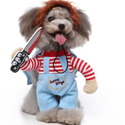 Dog toy dressed in a costume with a red wig, striped shirt, and blue overalls holding a toy knife.