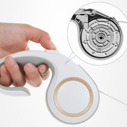 Hand holding a white electronic device with a close-up inset of its internal mechanism.