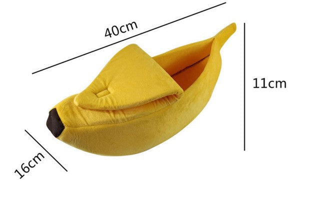 Yellow banana-shaped pet bed with measurements on a white background