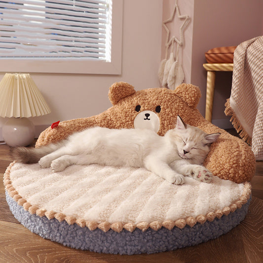 Cat lying on a fluffy teddy bear-shaped pet bed in a cozy room.