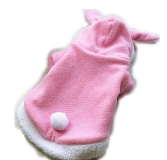 Pink dog coat with white trim and a white ball on a white background