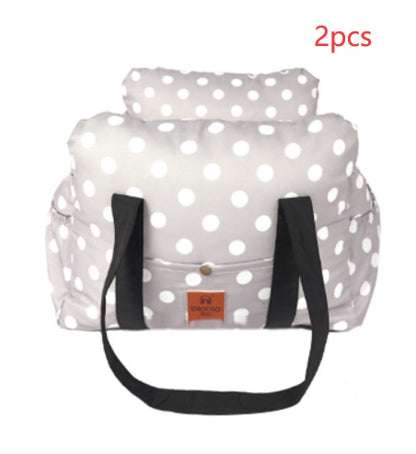 White polka dot bag with black straps on a white background