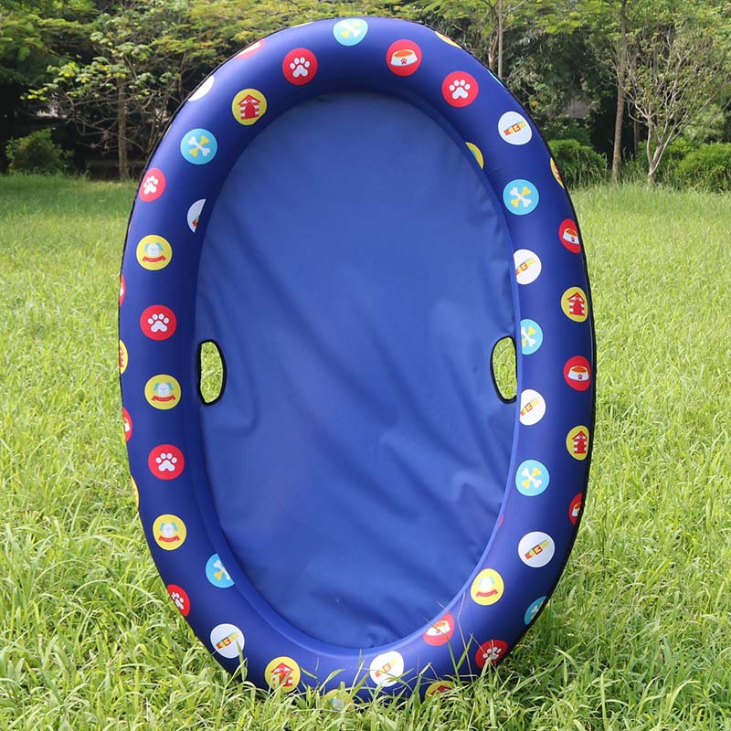 Blue inflatable pool with colorful designs on a grassy field