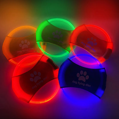 Colorful LED dog flying discs on a dark background