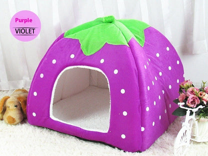 Purple pet bed shaped like a strawberry with a green top on a white background