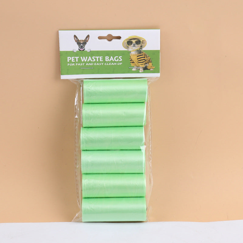 Pack of green pet waste bags with a brand label on a beige background