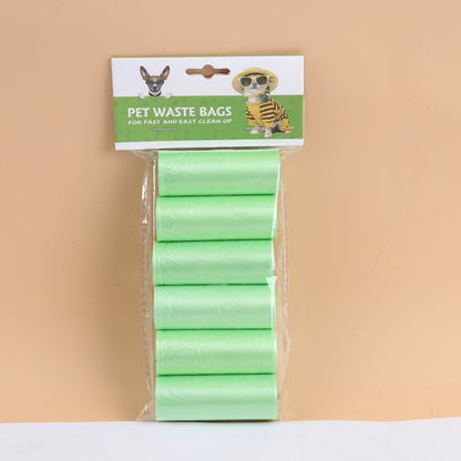 Pack of green pet waste bags with a brand label on a beige background