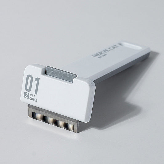 Pet grooming comb with brand name on a light gray background
