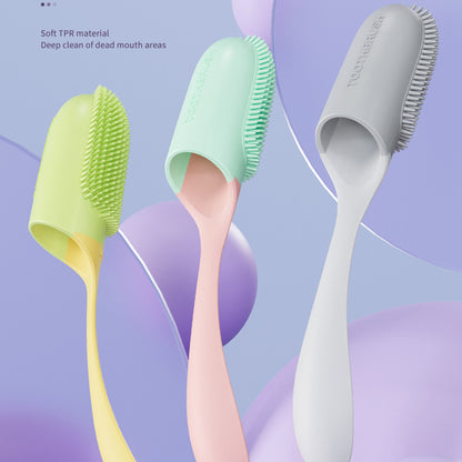 Three silicone toothbrushes in green, pink, and gray on a colorful abstract background.