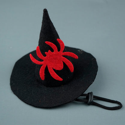 Black witch hat with a red spider design on a gray background