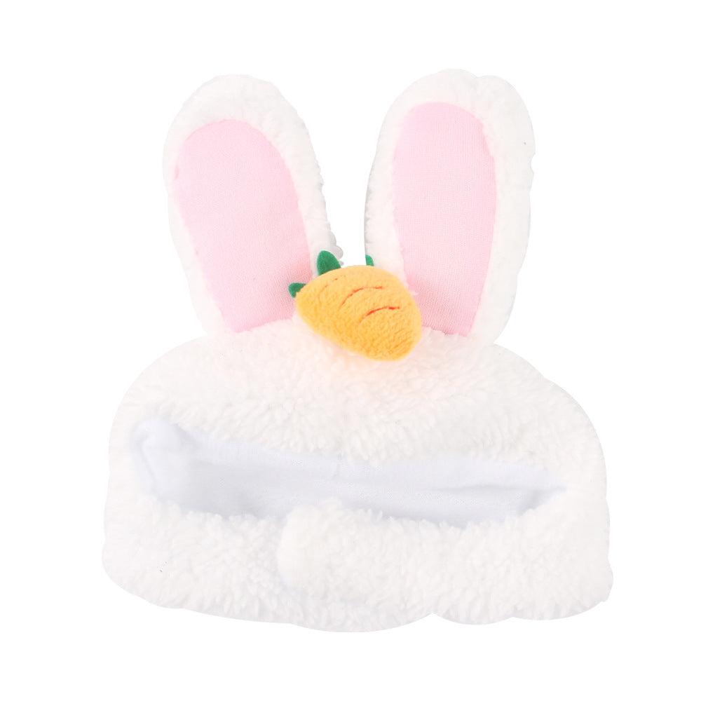 Plush toy with bunny ears and a carrot on a white background