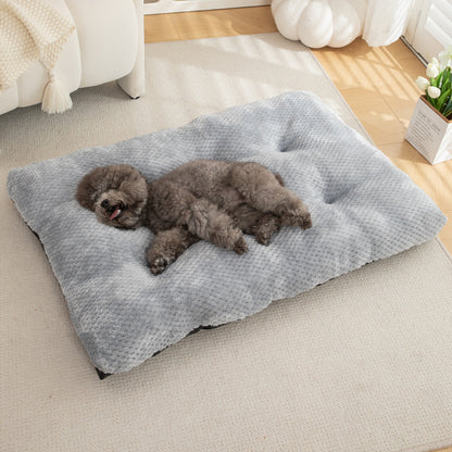 Dog lying on a gray pet bed in a cozy living room.