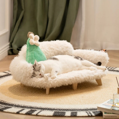 Cat lying on a fluffy pet bed with a green toy in a cozy room.