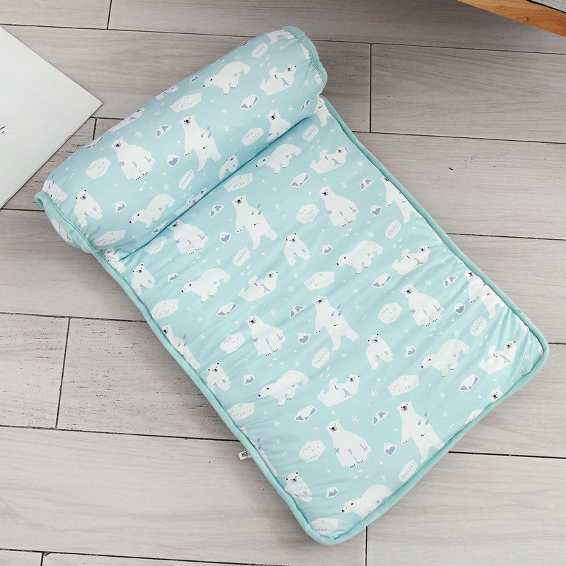Folded blanket with polar bear pattern on a wooden floor