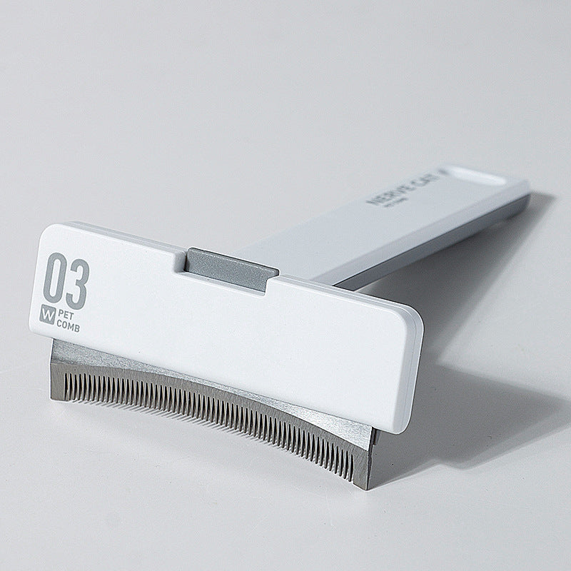 Pet grooming comb with a white handle and metal teeth on a gray background