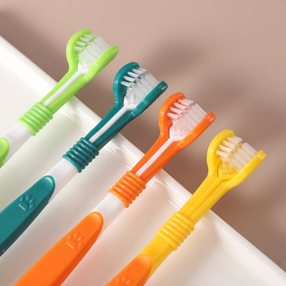 Set of colorful toothbrushes on a white surface with a brown background