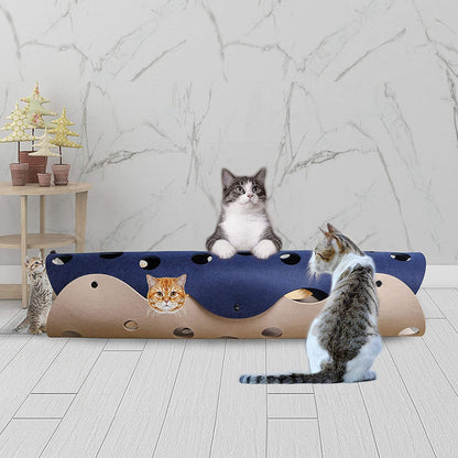 Cat playing with a blue and brown cat toy on a marble floor.