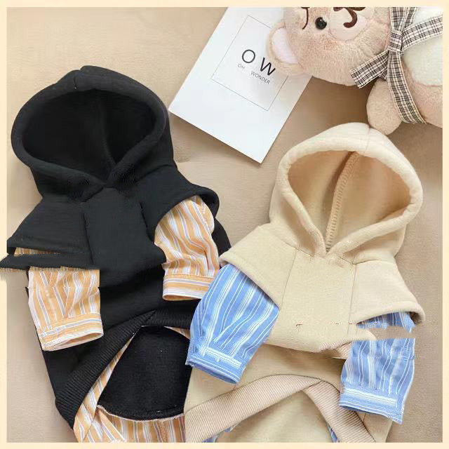 Two dog hoodies, one black and one beige, with colorful patterns on a neutral background.