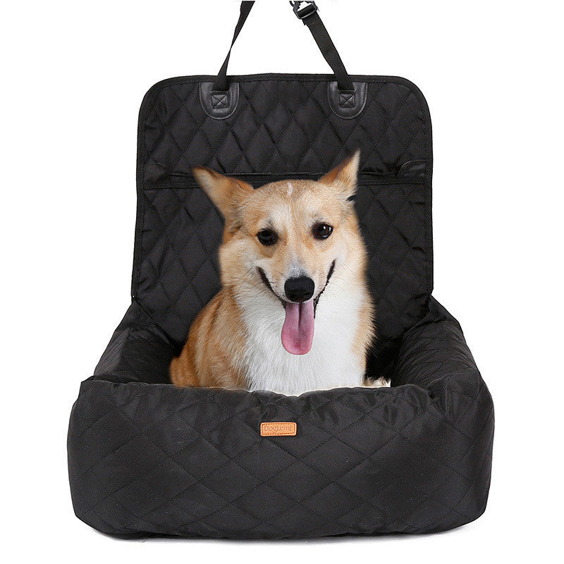 Black quilted pet car seat with a dog inside on a white background