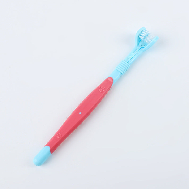 Children's toothbrush with pink handle and blue bristles on a light gray background