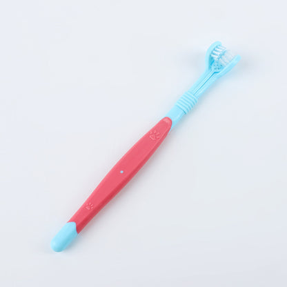 Children's toothbrush with pink handle and blue bristles on a light gray background