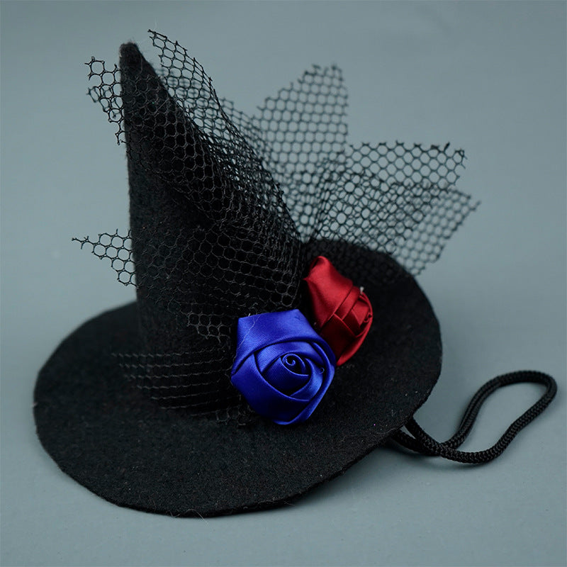 Black witch hat with blue and red roses on a gray background