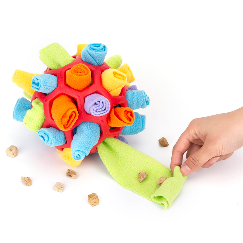 Colorful textured ball with a hand interacting with it on a white background