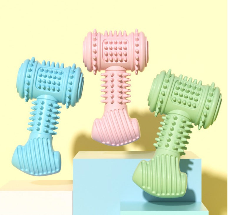 Three colorful dog toys shaped like dumbbells on a light yellow background.