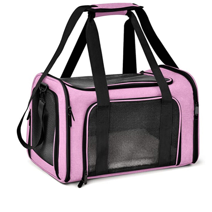 Pink pet carrier with black straps on a white background